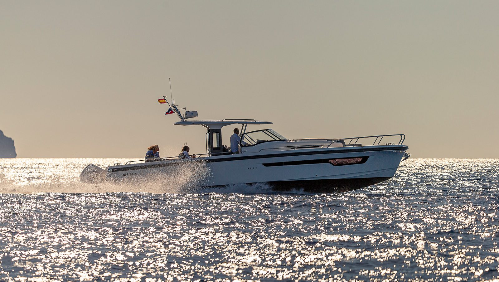 Boat from a far drivning fast in the ocean