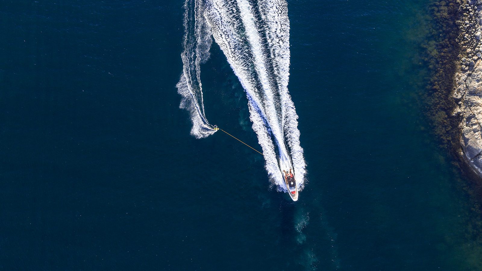 Boats driving in the ocean from above