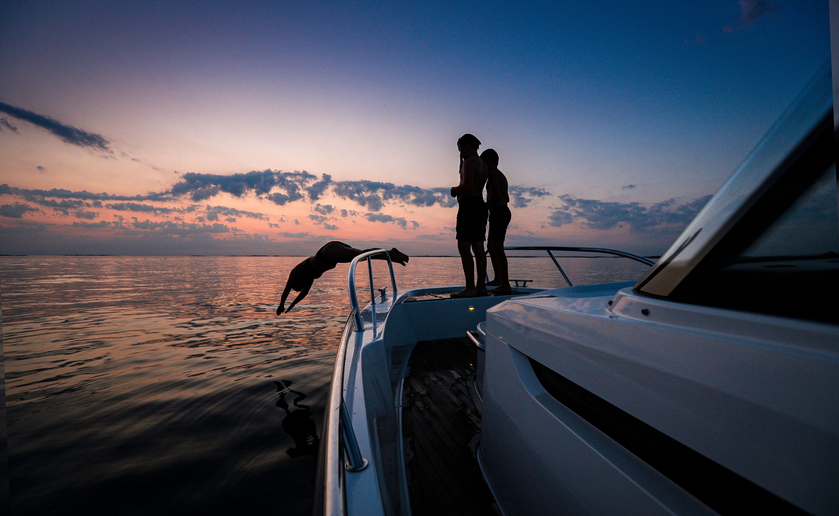 people on a boat enjoying the sunset