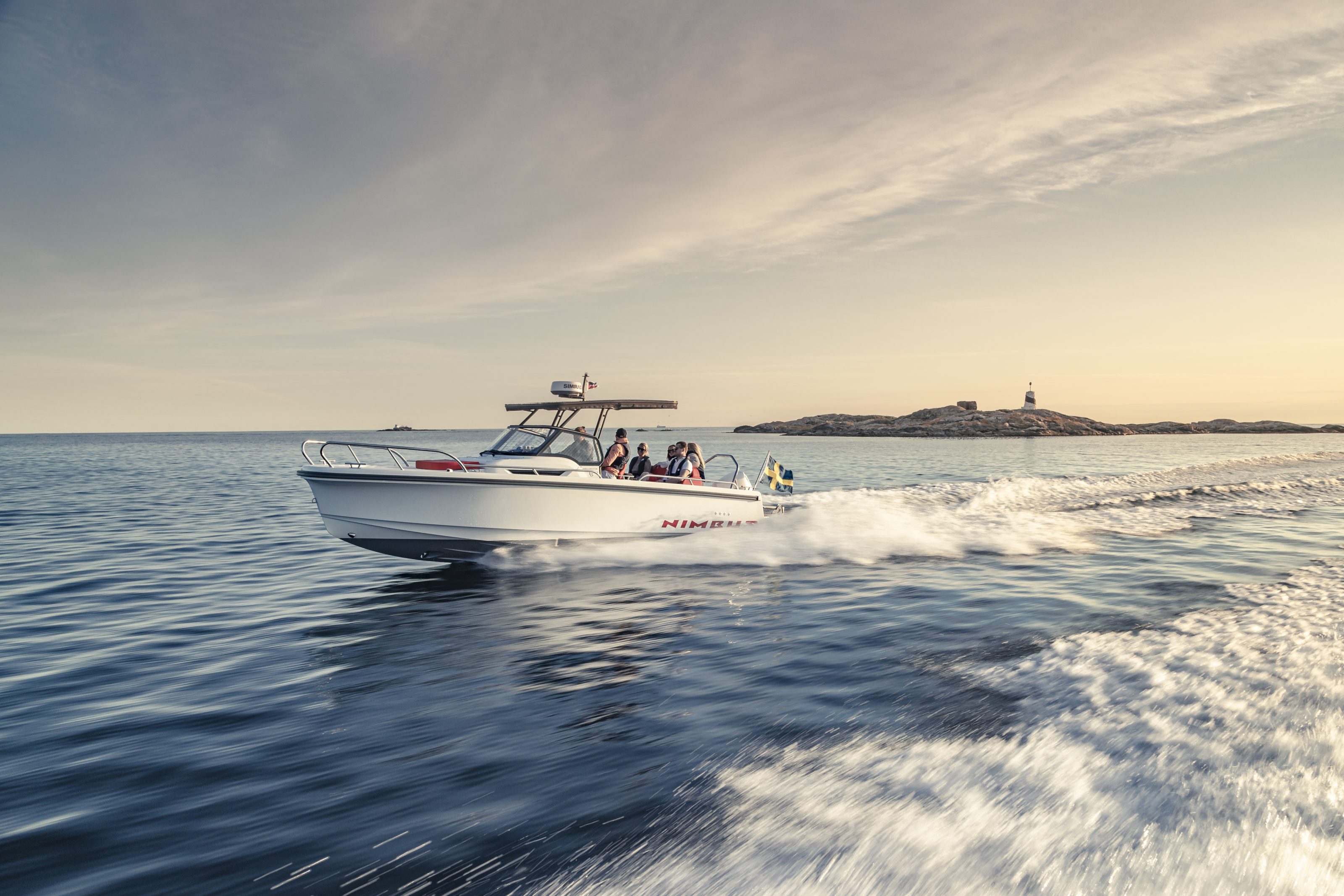 Boat in the sun driving with waves