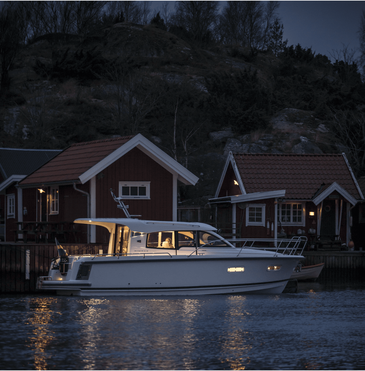 Nimbus boat in at night in the harbour